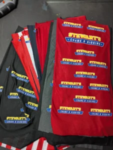 Custom branded neck gaiters for Stewart’s Crane & Rigging.