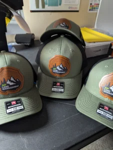 UV printed leatherette patch hats by Inkterra Prints.